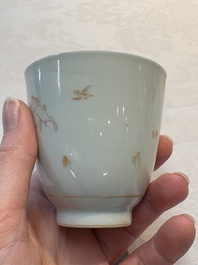 A Chinese iron-red-decorated 'boy and buffalo' cup and saucer and a famille rose 'Xi Xiang Ji' cup and saucer, Qianlong