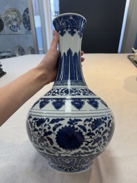 A Chinese blue and white 'flower scroll' bottle vase, Xuantong mark, 20th C.