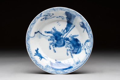 A Chinese blue and white 'Mongolian hunting' cup and saucer, jade mark, Kangxi