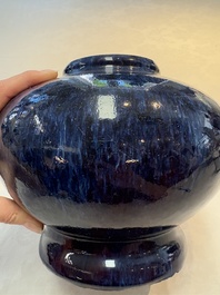 A Chinese flamb&eacute;-glazed vase on wooden stand, 19th C.