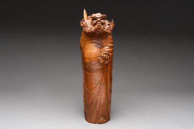 Three Chinese carved bamboo figures and a boxwood carving of a phoenix, 20th C.