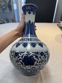 A Chinese blue and white 'flower scroll' bottle vase, Xuantong mark, 20th C.