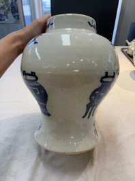 A Chinese blue and white vase and cover with calligraphy and antiquities, 19th C.
