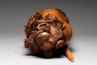 Three Chinese carved bamboo figures and a boxwood carving of a phoenix, 20th C.