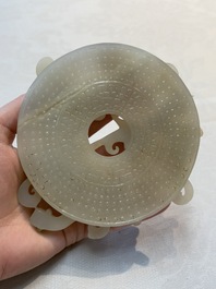 A Chinese carved white and russet jade bi-disc with chilong design, 19/20th C.