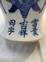 A Chinese blue and white vase and cover with calligraphy and antiquities, 19th C.