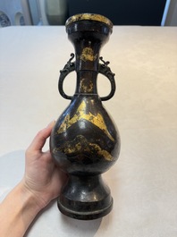 A Chinese parcel-gilt bronze vase with dragon-form handles, Yuan/Ming
