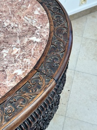 A Chinese finely carved hongmu marble top oval table, Canton, 19th C.