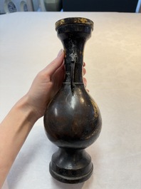 A Chinese parcel-gilt bronze vase with dragon-form handles, Yuan/Ming