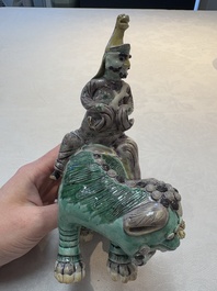A Chinese verte biscuit 'Sogdian riding a Buddhist lion' group, 19th C.