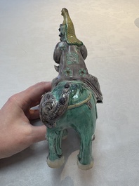 A Chinese verte biscuit 'Sogdian riding a Buddhist lion' group, 19th C.