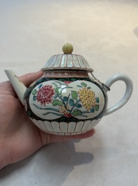 A Chinese famille rose black-ground teapot and stand with floral design, Yongzheng/Qianlong