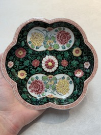 A Chinese famille rose black-ground teapot and stand with floral design, Yongzheng/Qianlong