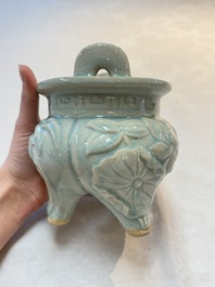 A Chinese qingbai tripod censer with floral relief design, Song/Yuan
