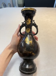 A Chinese parcel-gilt bronze vase with dragon-form handles, Yuan/Ming