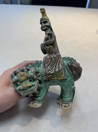 A Chinese verte biscuit 'Sogdian riding a Buddhist lion' group, 19th C.
