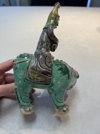 A Chinese verte biscuit 'Sogdian riding a Buddhist lion' group, 19th C.