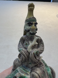 A Chinese verte biscuit 'Sogdian riding a Buddhist lion' group, 19th C.