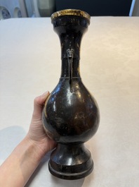A Chinese parcel-gilt bronze vase with dragon-form handles, Yuan/Ming