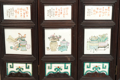 A rare Chinese eight-panel hongmu room divider with 48 qianjiang cai plaques, signed Jia Xingqing 贾醒卿, dated 1902