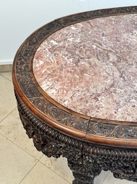A Chinese finely carved hongmu marble top oval table, Canton, 19th C.
