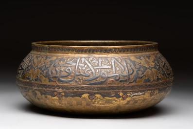 A Persian silver- and copper-inlaid 'calligraphic' brass bowl, 18th C.