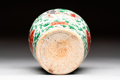A small Chinese wucai 'Buddhist lion and peony scrolls' jar, Transitional period