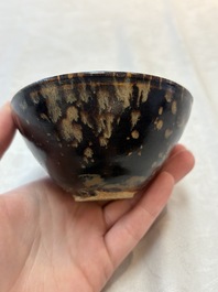 A Chinese Jizhou tortoiseshell-glazed tea bowl, a ewer and a black-glazed vase, Jin and later