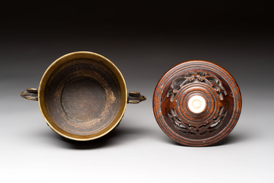 A Chinese archaistic bronze censer with a wooden cover, Xuande mark, 19th C.