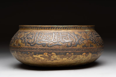 A Persian silver- and copper-inlaid 'calligraphic' brass bowl, 18th C.