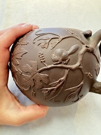 A Chinese Yixing stoneware 'squirrels among grapevines' teapot and cover, Kangxi