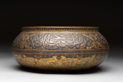 A Persian silver- and copper-inlaid 'calligraphic' brass bowl, 18th C.