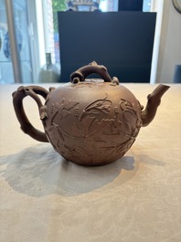 A Chinese Yixing stoneware 'squirrels among grapevines' teapot and cover, Kangxi