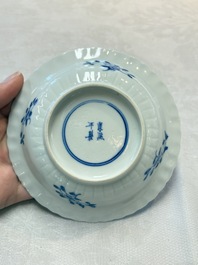 A set of six Chinese blue and white cups and saucers with floral design, Kangxi mark, 19th C.