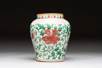 A small Chinese wucai 'Buddhist lion and peony scrolls' jar, Transitional period