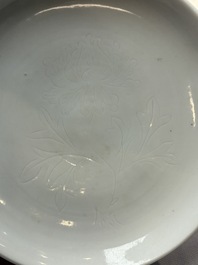 A Chinese Dehua blanc de Chine incised 'peony' plate, 17/18th C.