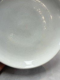 A Chinese Dehua blanc de Chine incised 'peony' plate, 17/18th C.