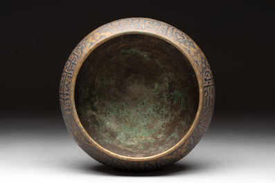 A Persian silver- and copper-inlaid 'calligraphic' brass bowl, 18th C.
