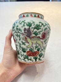 A small Chinese wucai 'Buddhist lion and peony scrolls' jar, Transitional period
