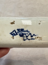 A Chinese blue and white wrist rest with figural design, 19th C.