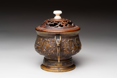 A Chinese archaistic bronze censer with a wooden cover, Xuande mark, 19th C.