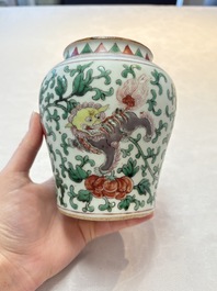 A small Chinese wucai 'Buddhist lion and peony scrolls' jar, Transitional period