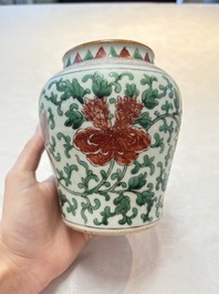 A small Chinese wucai 'Buddhist lion and peony scrolls' jar, Transitional period