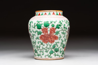 A small Chinese wucai 'Buddhist lion and peony scrolls' jar, Transitional period