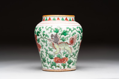 A small Chinese wucai 'Buddhist lion and peony scrolls' jar, Transitional period