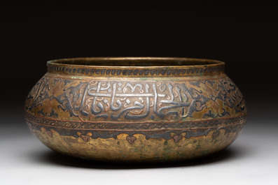 A Persian silver- and copper-inlaid 'calligraphic' brass bowl, 18th C.