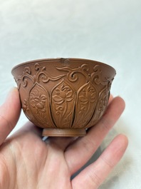 A set of five Chinese Yixing stoneware cups with floral design, Kangxi