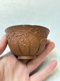 A set of five Chinese Yixing stoneware cups with floral design, Kangxi