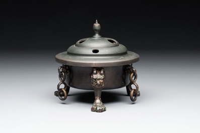 A Chinese bronze tripod censer and cover, Sui/Tang