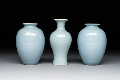 Three Chinese claire-de-lune vases on wooden stands, Kangxi mark, 19th C.